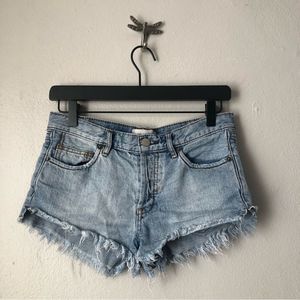 Free People *We the Free* cut off shorts in light wash distressed denim size 24